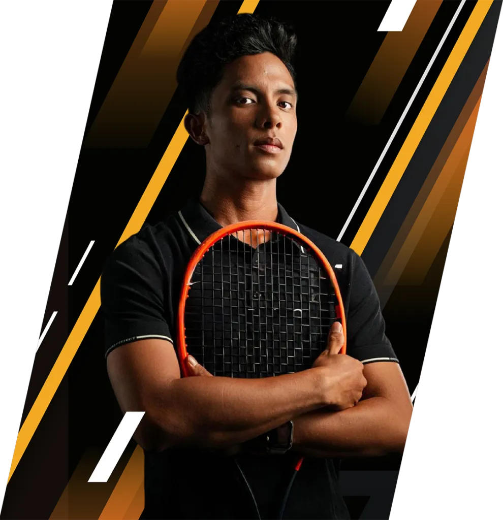 Coach Norman Joseph Enriquez holding a racquet, arms folded