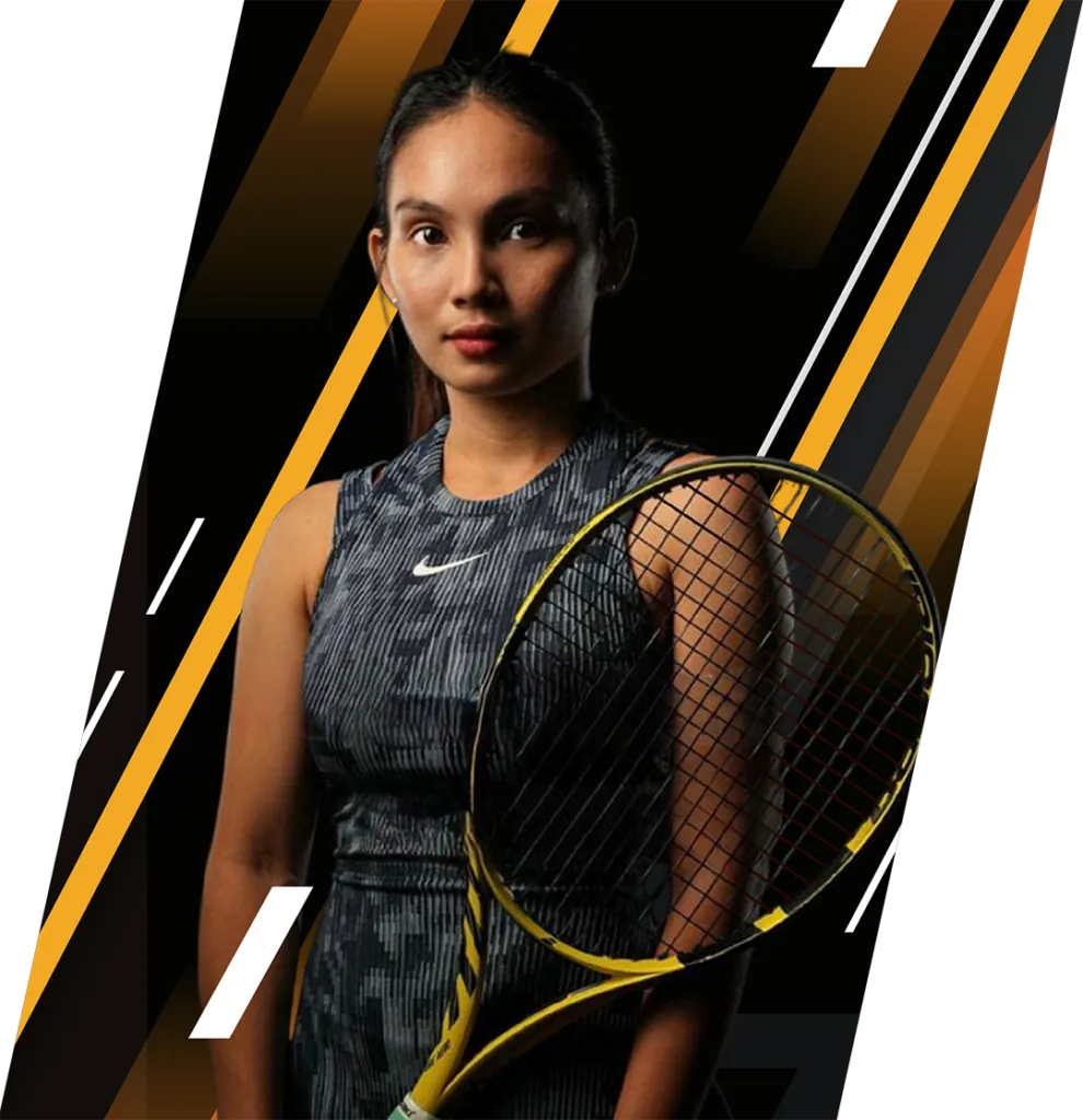 Coach Shyne Villareal in a studio portrait, racquet held across her body