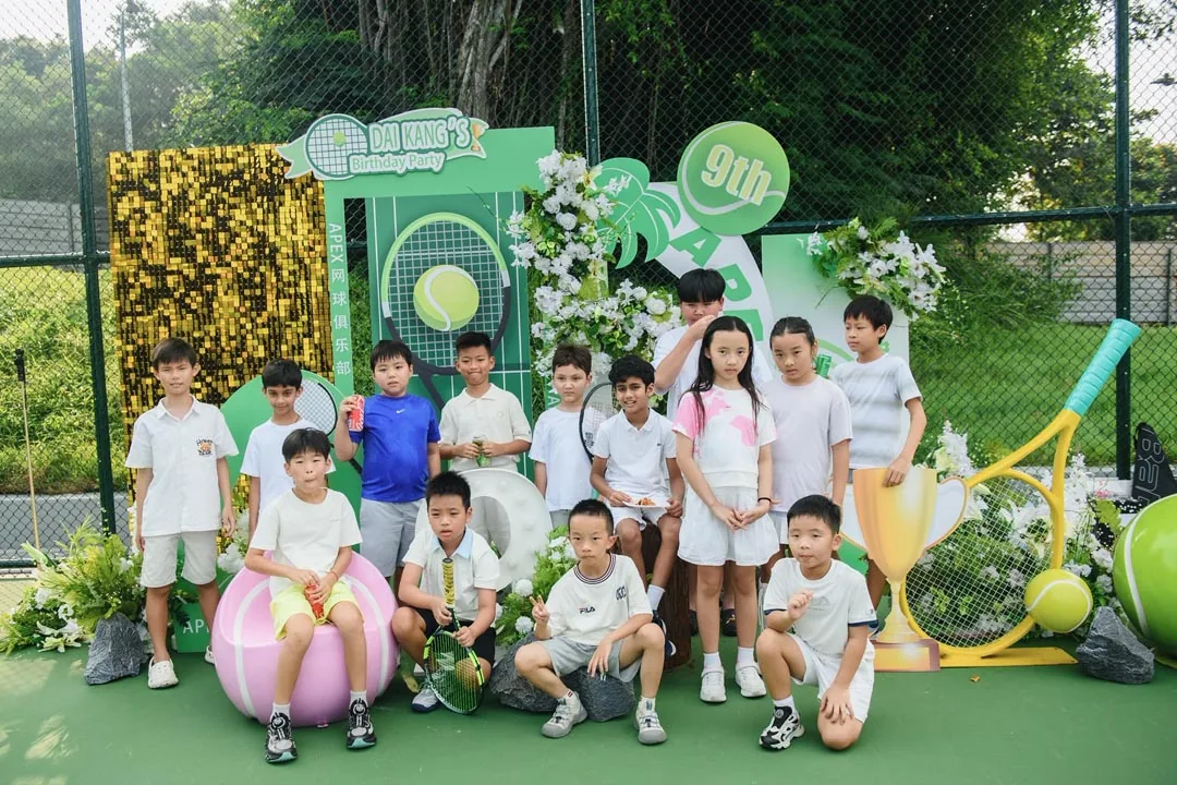 The junior squad posed in front of the decorated backdrop